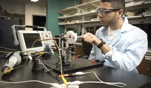 Federico G. Hita (ND '21) fine tunes a hand-cranked piezoelectric device