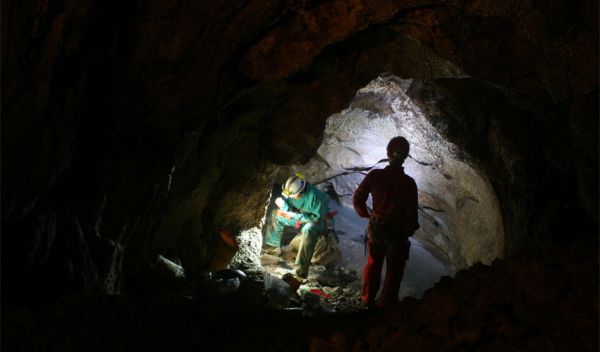 Photo of researchers collecting microbial biofilms in the Frasassi cave system, central Italy.