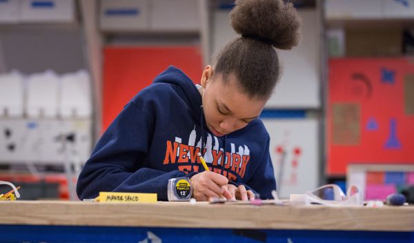 A student calculates measurements in one of the makerspaces involved in Designing for Diversity.