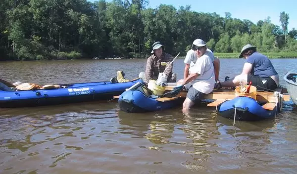 Photo of researchers collecting a sediment core from Silver Lake, Ohio.