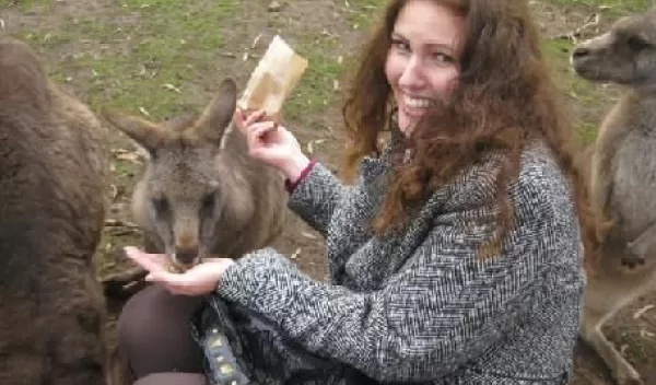 Photo of Michelle Meighan feeding a kangaroo during her summer in Tasmania.