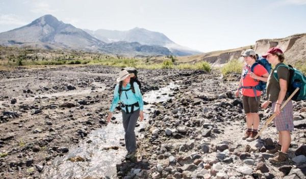 Carri LeRoy teaches students about aquatic and terrestrial environments at a stream near Mount St. Helens