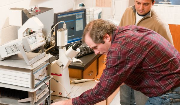 Photo of researchers Bret Flanders and Prem Thapa in their laboratory at Kansas State University.