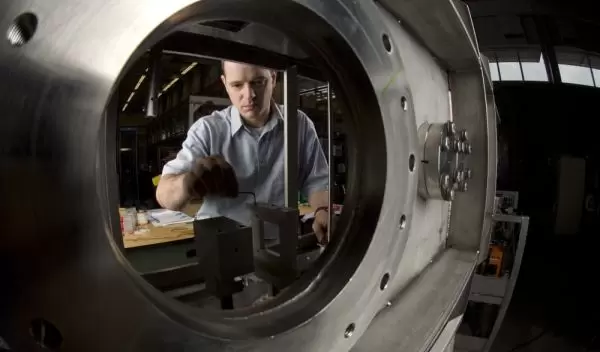 Photo of Ben Arend installing a detector during the reconfiguration of the NSCL's experimental area.