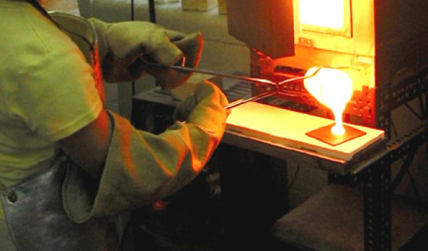 Photo of Amy Barnes making phosphorus-rich phosphate glass to use with her doctoral research work.