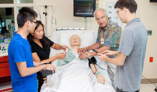 researcher and students experiment with a mannequin