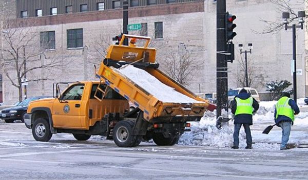 workers spreading salt from a salt truck
