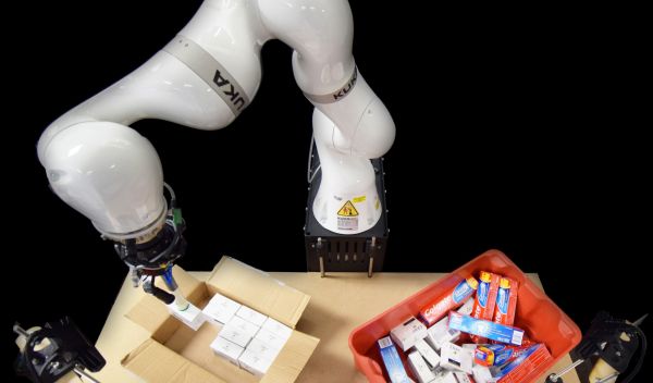 robotic arm packs items into a box