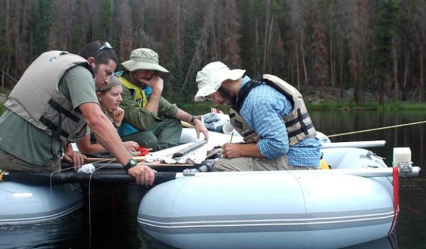 Paleoecologists study a sediment core from Chickaree Lake in the Rocky Mountains.