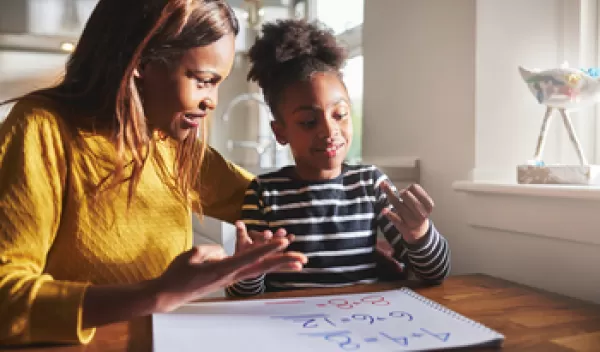 Parent helping daughter with math.
