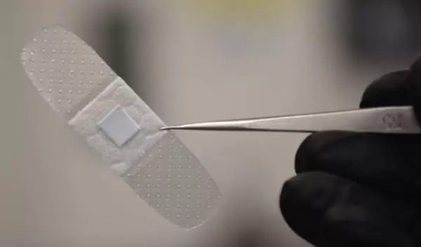 smart bandage held by tweezers