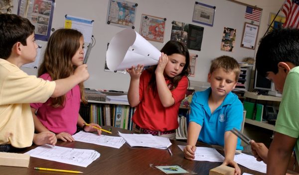 Students test for sound during a science experiment