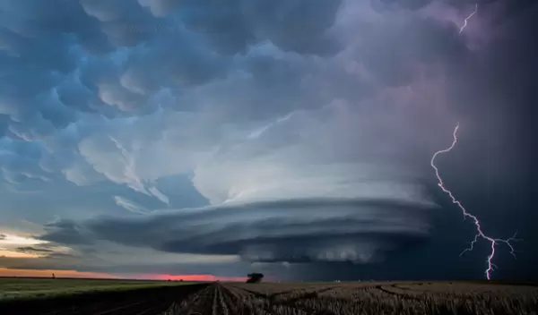 Shelf cloud with lighting over a field