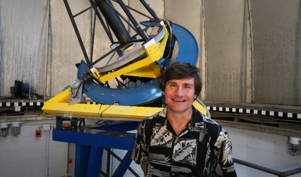 Photo showing Alex Filippenko in front of the Katzman Automatic Imaging Telescope.