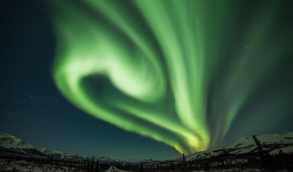 The aurora borealisâ swirling curtains of green light, captured in Alaska.