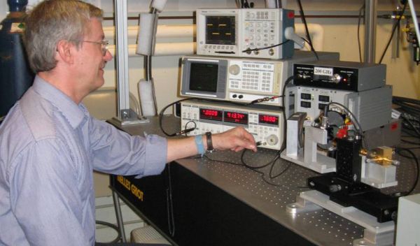 Photo of William Stillman in the lab evaluating the effects of focused terahertz radiation.