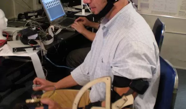 University of Michigan engineering researcher Brent Gillespie uses a prototype of a device.