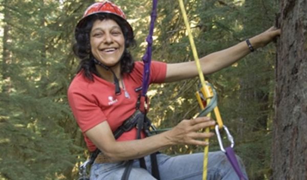 Photo shows Nalini Nadkarni and ropes and pulleys she uses as a canopy researcher.