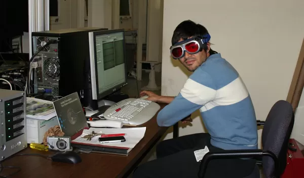 Photo of Raul Cal modeling the cool laser eye-protecting glasses used during the experiments.