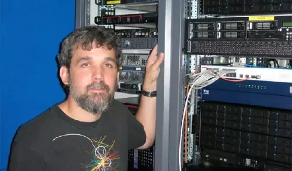 Photo of Shawn McKee with components of the UltraLight system