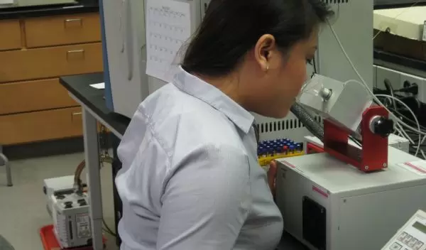 student in front of a microscope