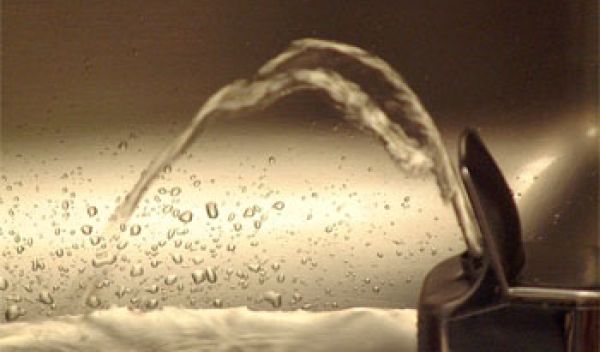 Photo of a water coming out of a water fountain.