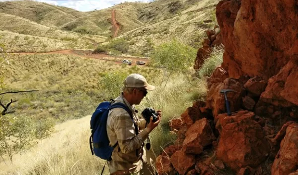 Benjamin Johnson woks at an outcrop in remote Western Australia