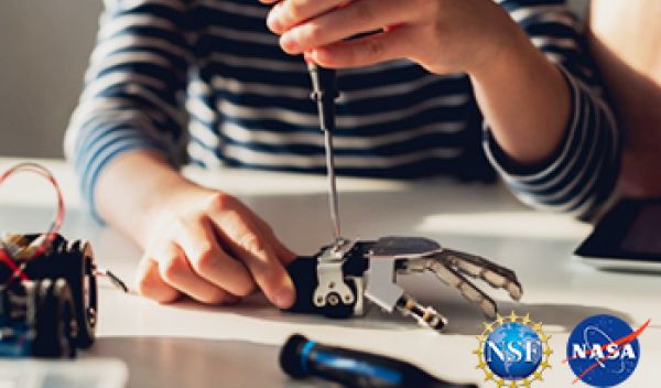 female putting together a robot hand with NSF NASA logos placed on top