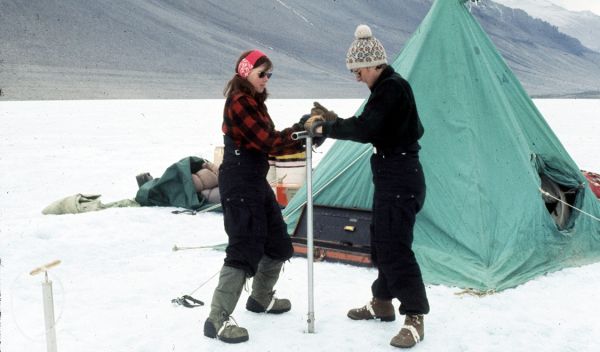 Photo of women geoscientists using a hand augur to drill Lake Vanda, Antarctica, in 1969-1970.