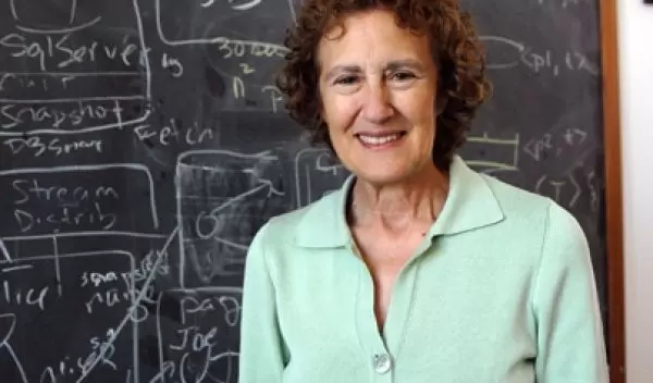 Photo of Barbara Liskov of MIT in front of a chalk board.