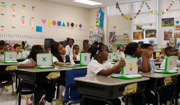 Photo of students using XO laptops.