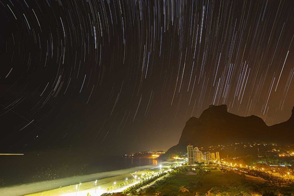 Star trials and light pollution over Rio beach at night