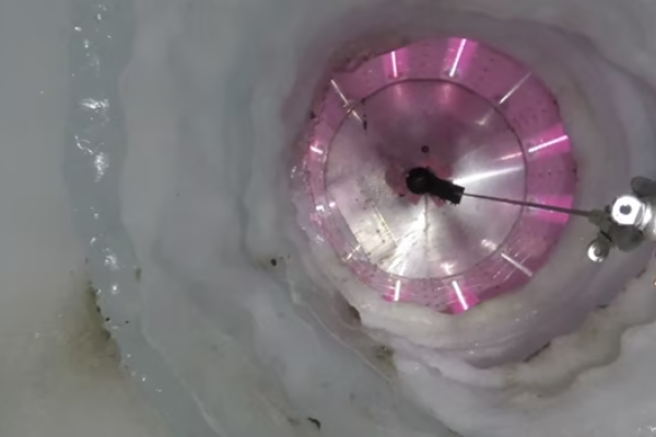Instruments descend 1,100 meters (3,500 feet) down a borehole to Antarctica's Mercer Subglacial Lake. The UV collar of the borehole lights up, irradiating any sources of contamination.