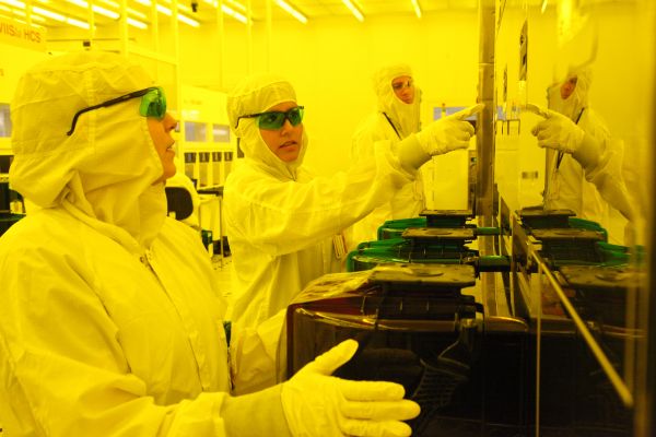 Technicians in clean room learn how to operate the equipment used to make semiconductors