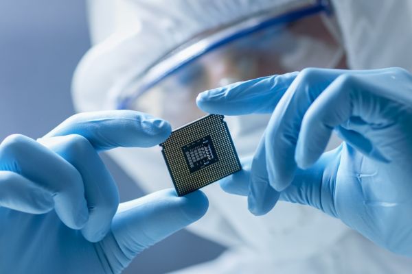 lab worker holds computer chip