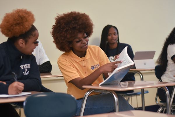 College students sitting at desks in a classroom.