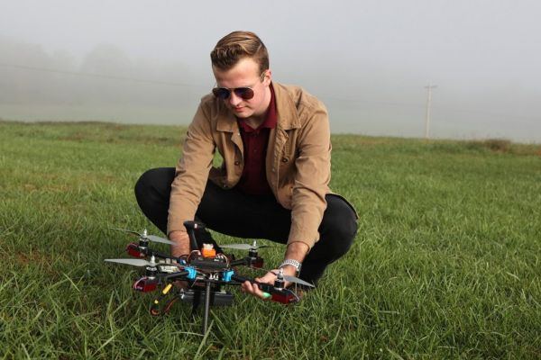 Garrett Asper prepares a multi-rotor drone for a series of test flights