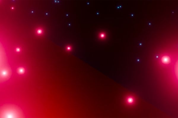 Red and blue particles against a dark background.