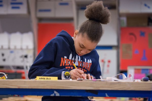 A student calculates measurements in one of the makerspaces involved in Designing for Diversity.